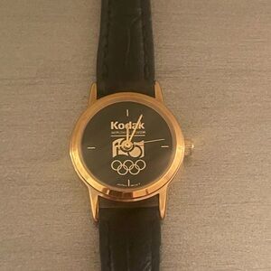 Kodak Olympics Ladies Watch Vintage Genuine Black Leather Yellow Gold Tone Case